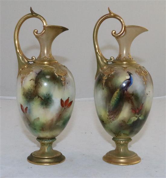 A pair of Royal Worcester peacock painted ewers, c.1905, 20.3cm (8in.), one restored